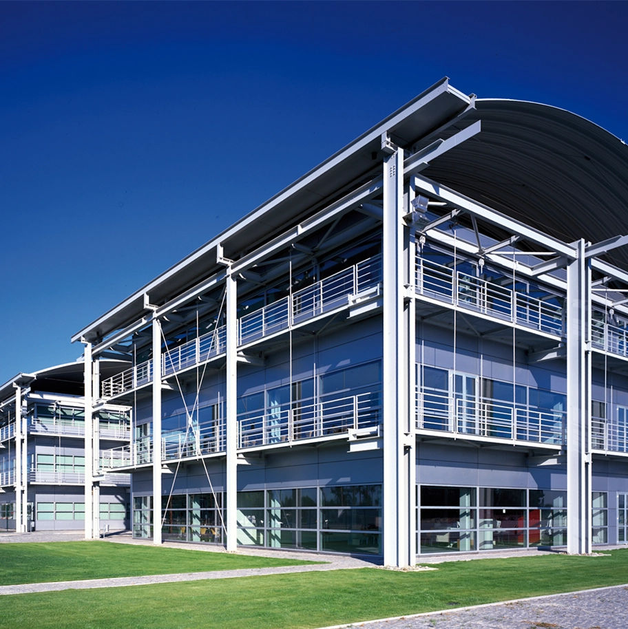 The exterior of a modern building under a clear blue sky.